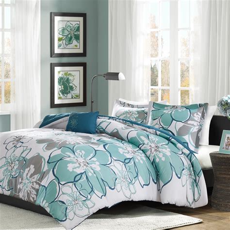 The pieced design features polka dots, a damask motif, and leopard print in a bold color palette of black, white, and teal. . Mi zone comforter set